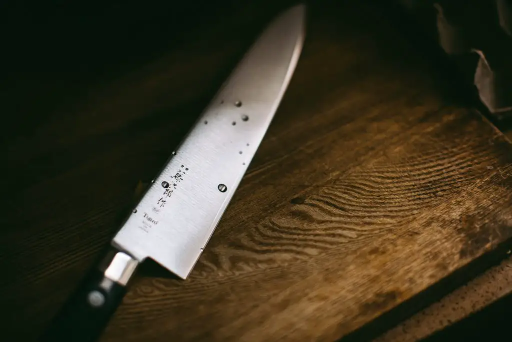 A sharp kitchen knife on a wooden surface