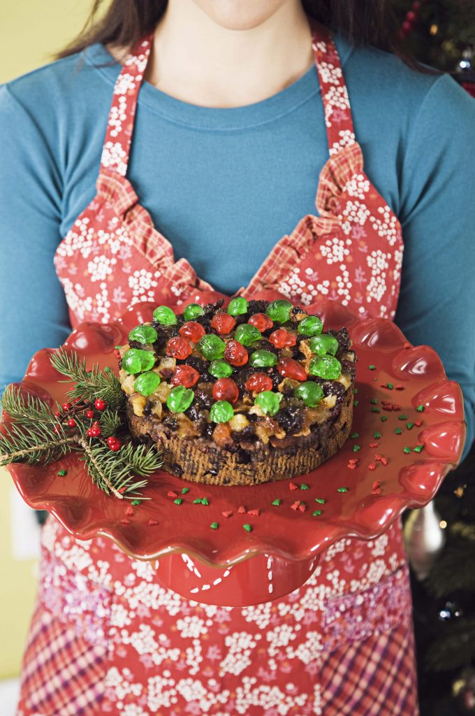 Woman holding a round fruitcake