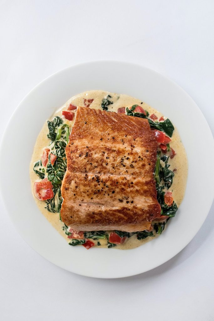 A salmon meal drenched on creamy milk