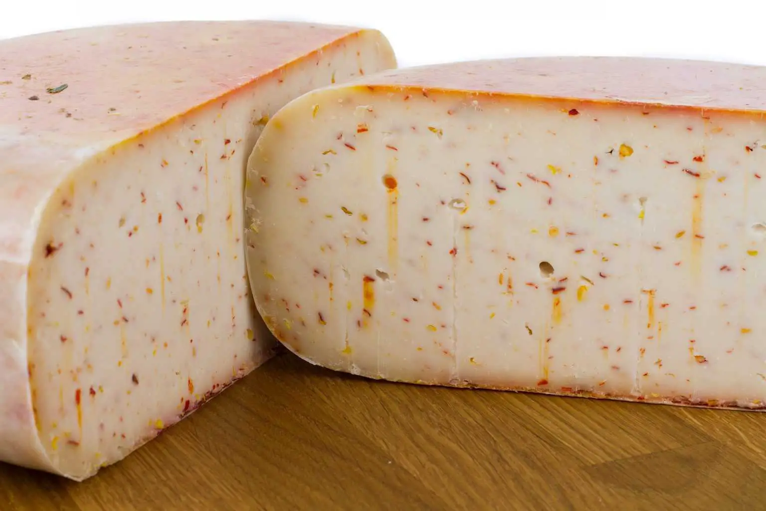 A circular bulk of goat cheese split in half
