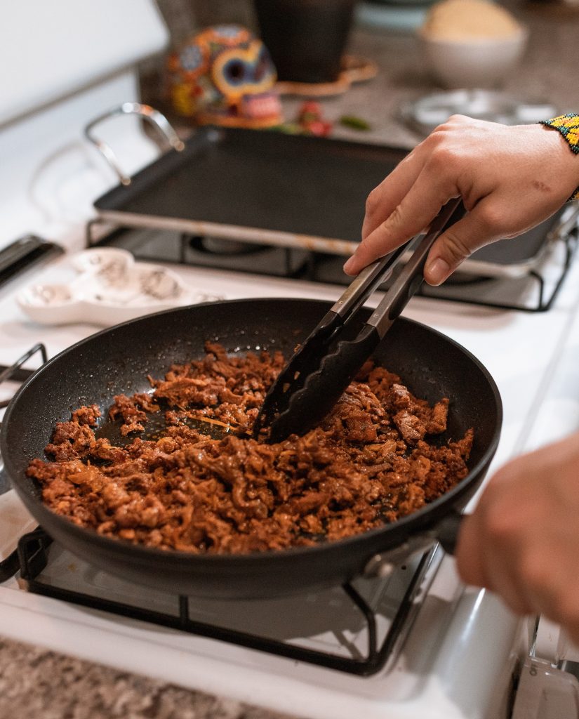 Cooking carne molida on a stove