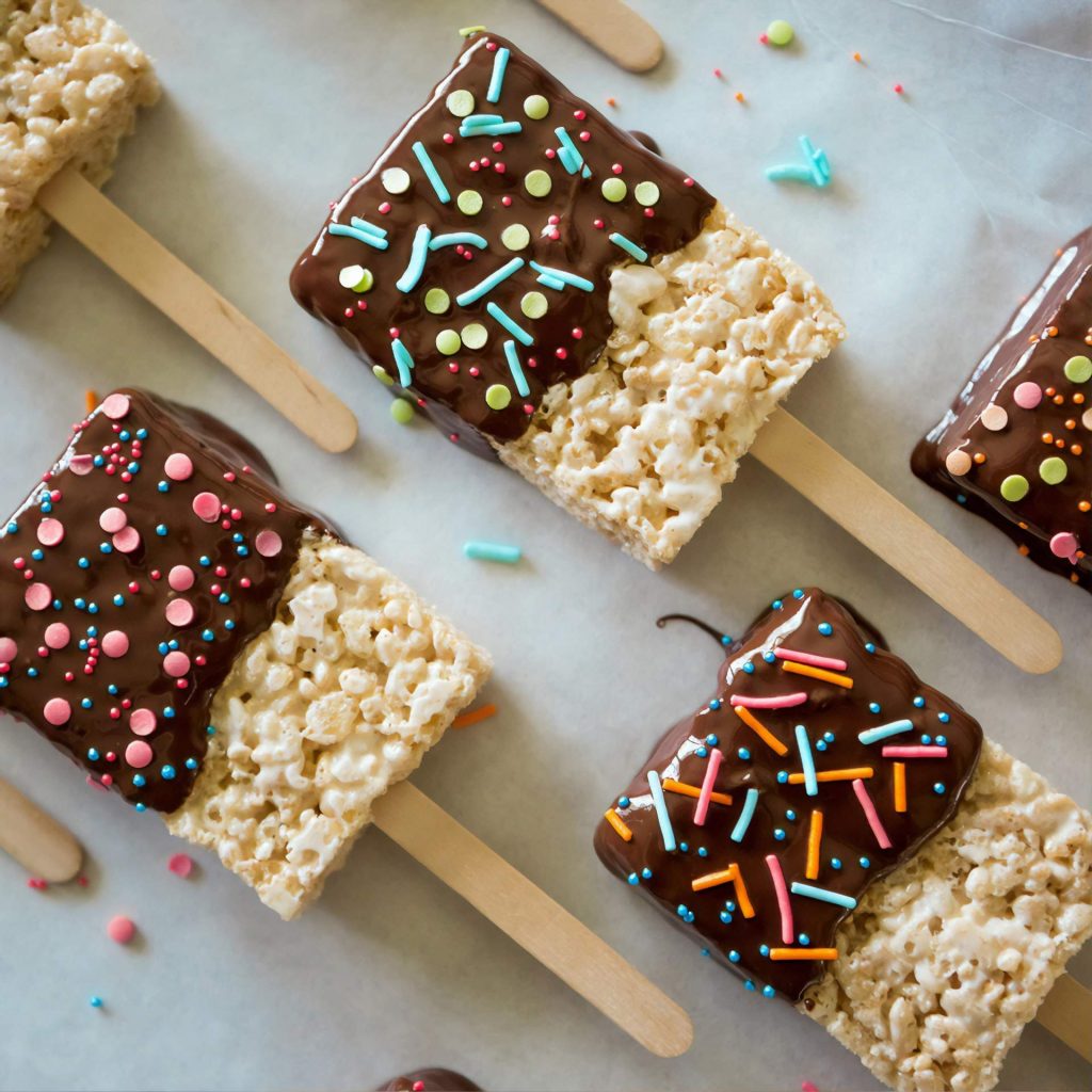 Rice Krispies topped with melted chocolate and sprinkles