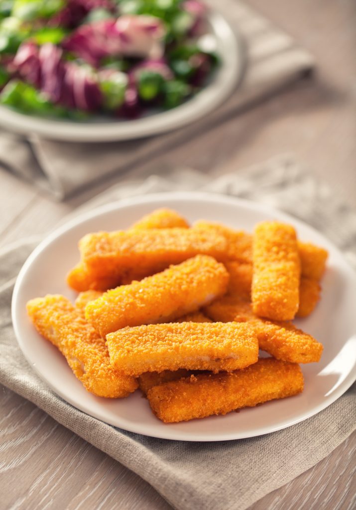 Crispy fish sticks on a white plate