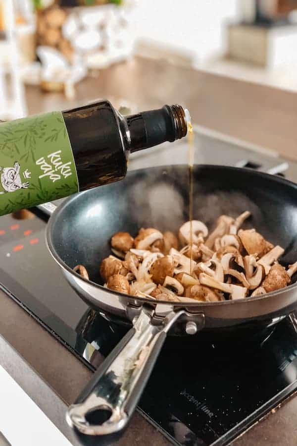 Liquid seasoning pouring on a saute pan