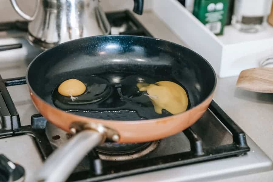 Frying two eggs on a pan