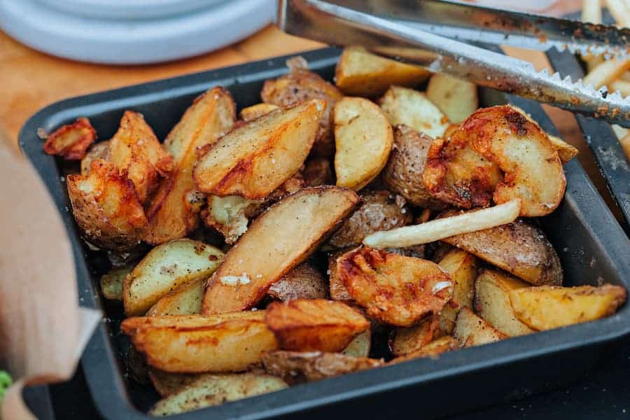 Cooked potatoes on a roasting pan