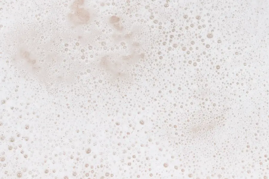 Close-up of white bubbles from white soap used for cleaning