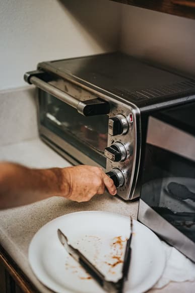 Person using an oven toaster