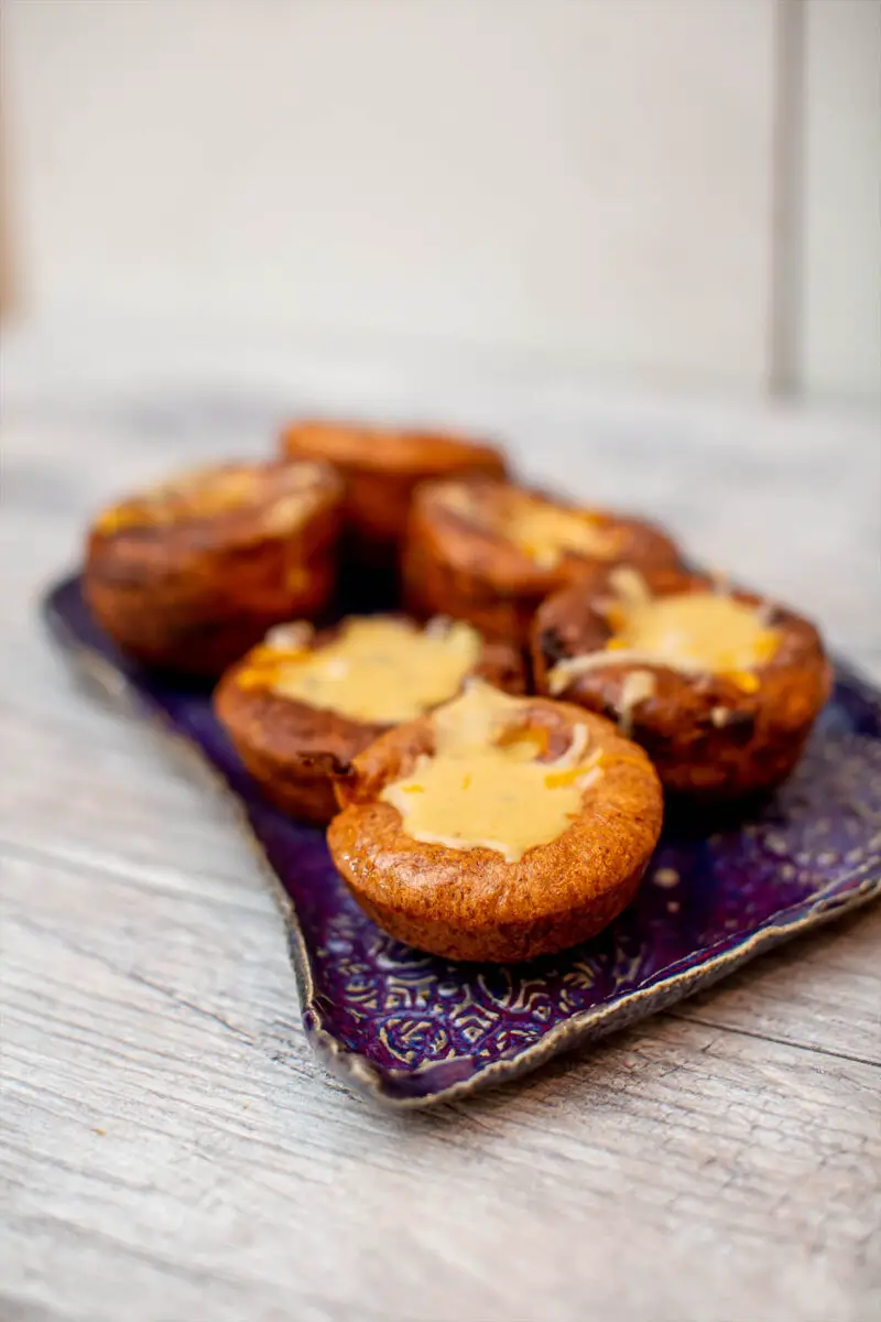 6 Yorkshire popovers on a purple ceramic plate sitting on a neutral gray countertop