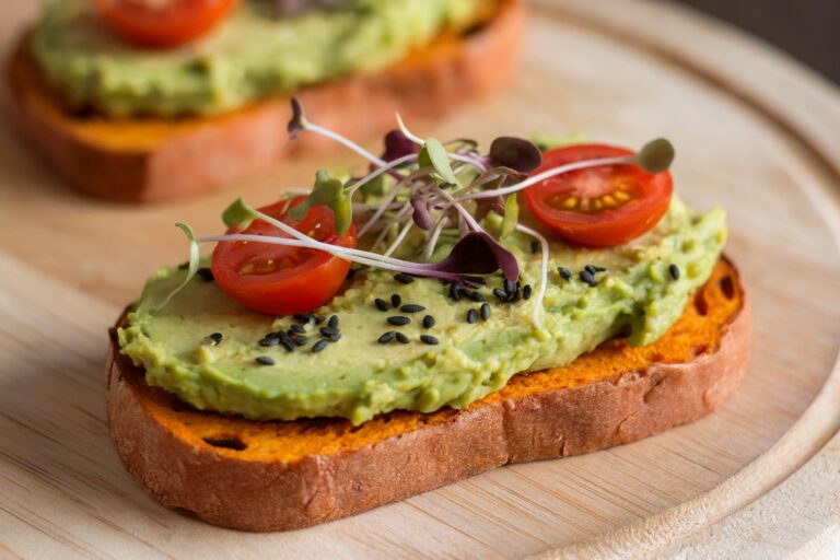 Sweet potato toast with avocado, cherry tomatoes, and microgreens